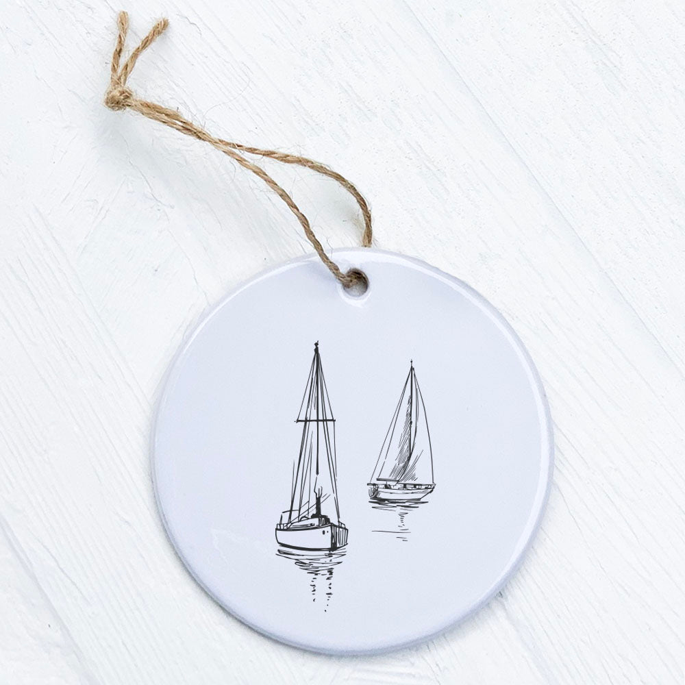 A beautifully crafted porcelain ornament featuring sketched sailboats, showcasing vibrant colors and a glossy finish.