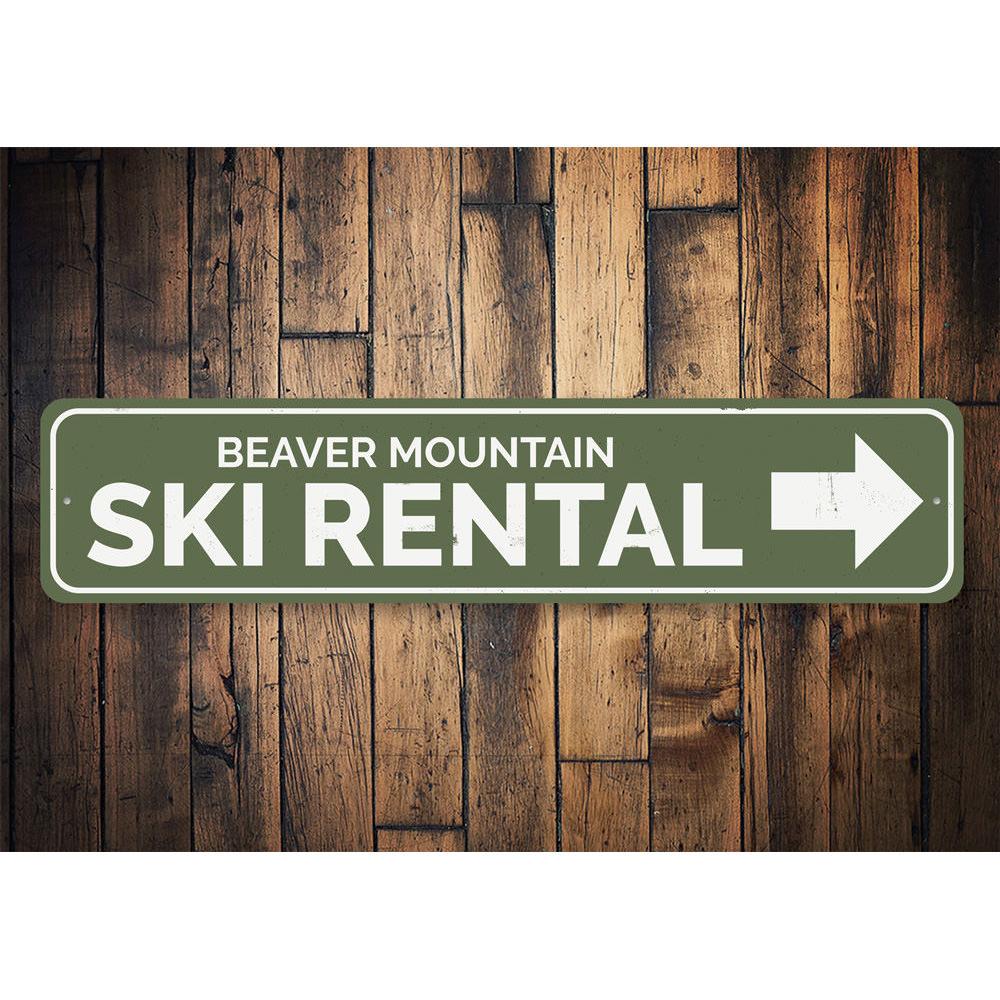 A decorative Ski Rental Arrow Sign made of aluminum, featuring customizable text, ideal for ski lodges and enthusiasts.