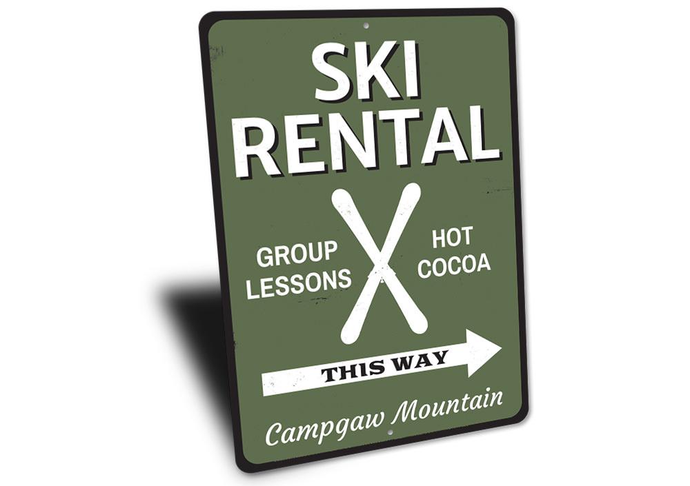 A decorative Ski Rental This Way Sign made of durable aluminum, featuring customizable text and pre-drilled holes for easy mounting.