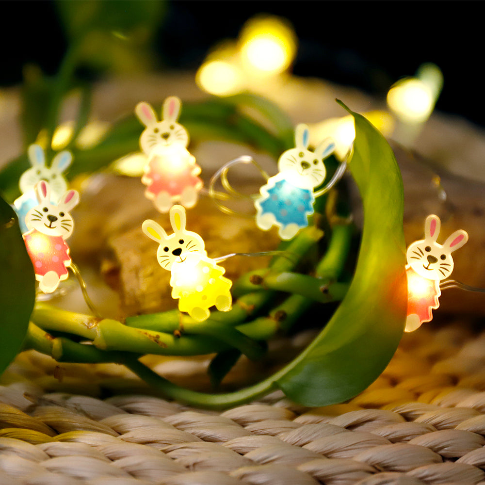 A string of 30 LED bunny-shaped lights on copper wire, perfect for Easter decorations, showcasing a warm white glow.