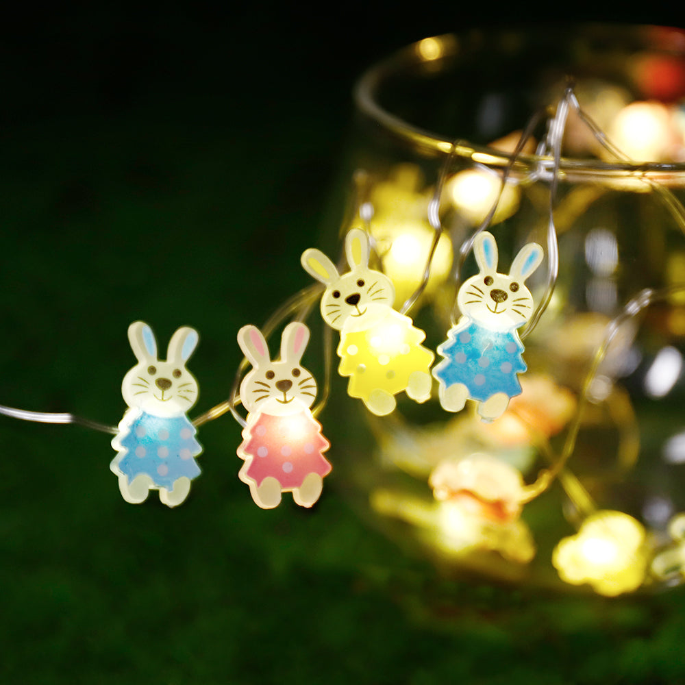 A string of 30 LED bunny-shaped lights on copper wire, perfect for Easter decorations, showcasing a warm white glow.