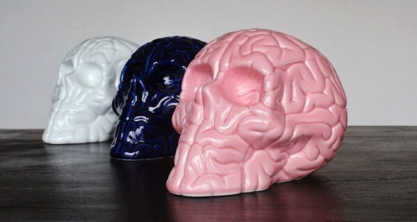 Skull Brain 'PINK' sculpture by Emilio Garcia, crafted from white porcelain with a vibrant pink enamel finish, showcasing a unique artistic design.