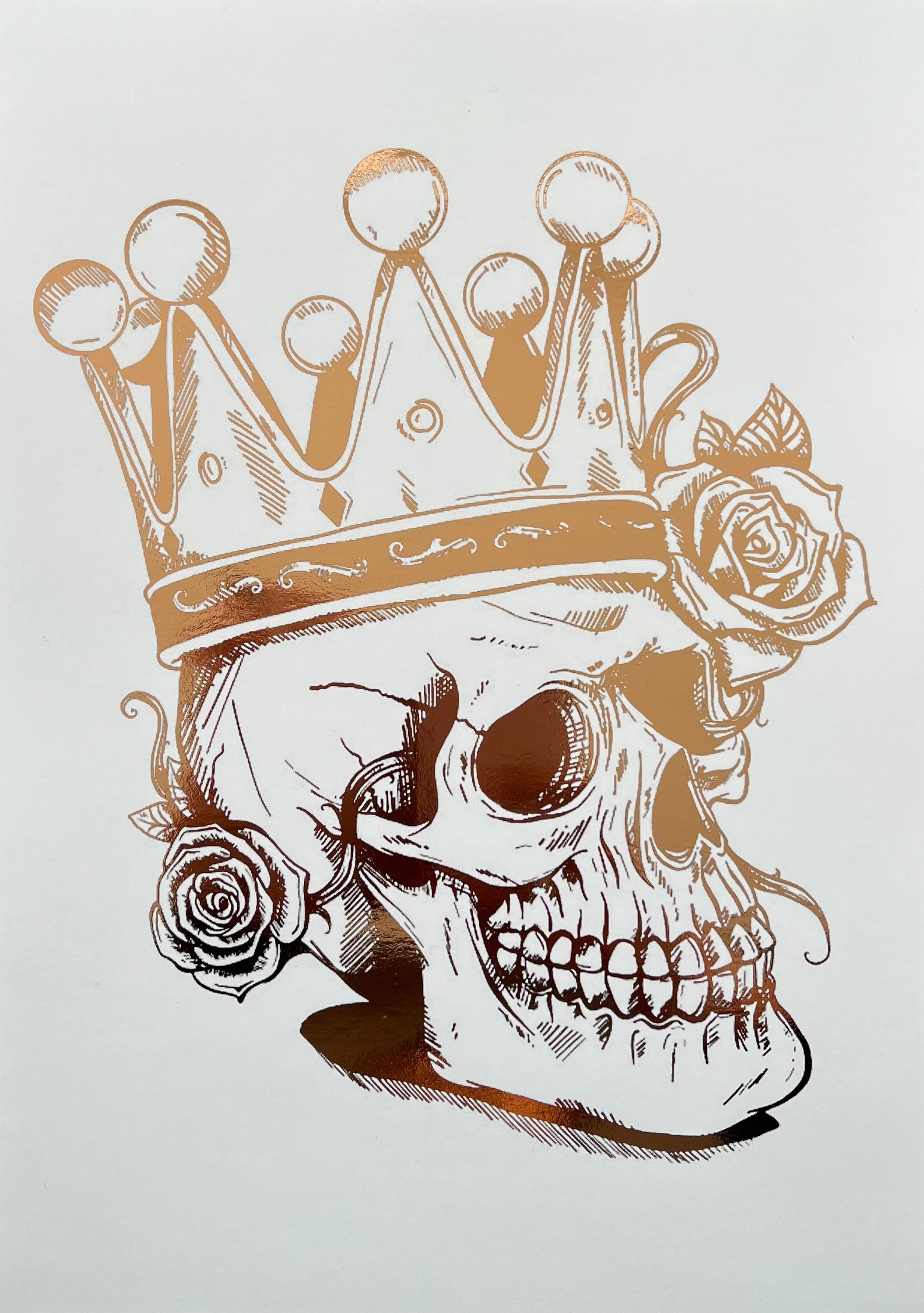 A striking rose gold foil print featuring a skull adorned with a majestic crown, showcasing intricate details and luxurious accents.