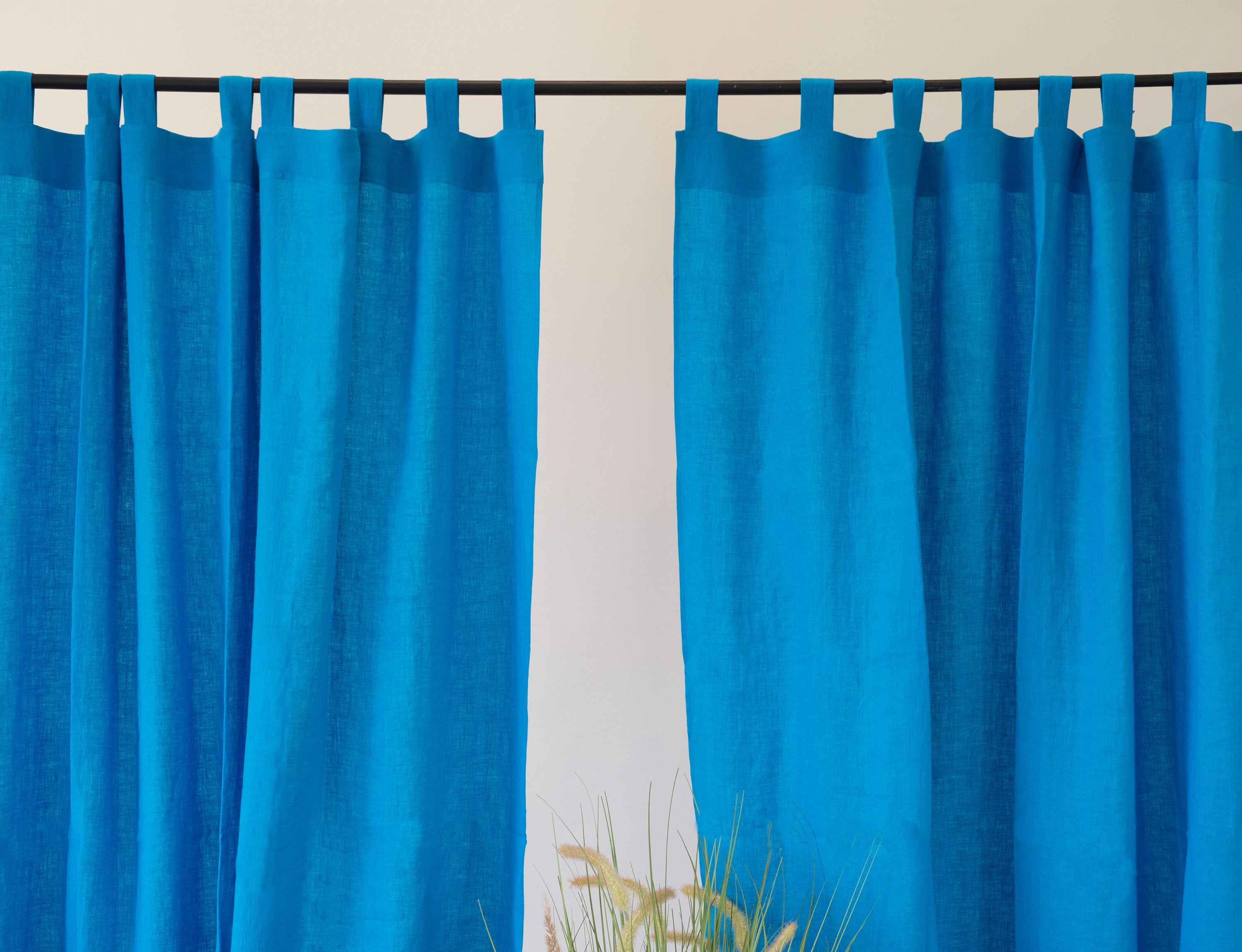 Sky Blue linen curtain with tab tops, showcasing a modern design and semi-sheer fabric.