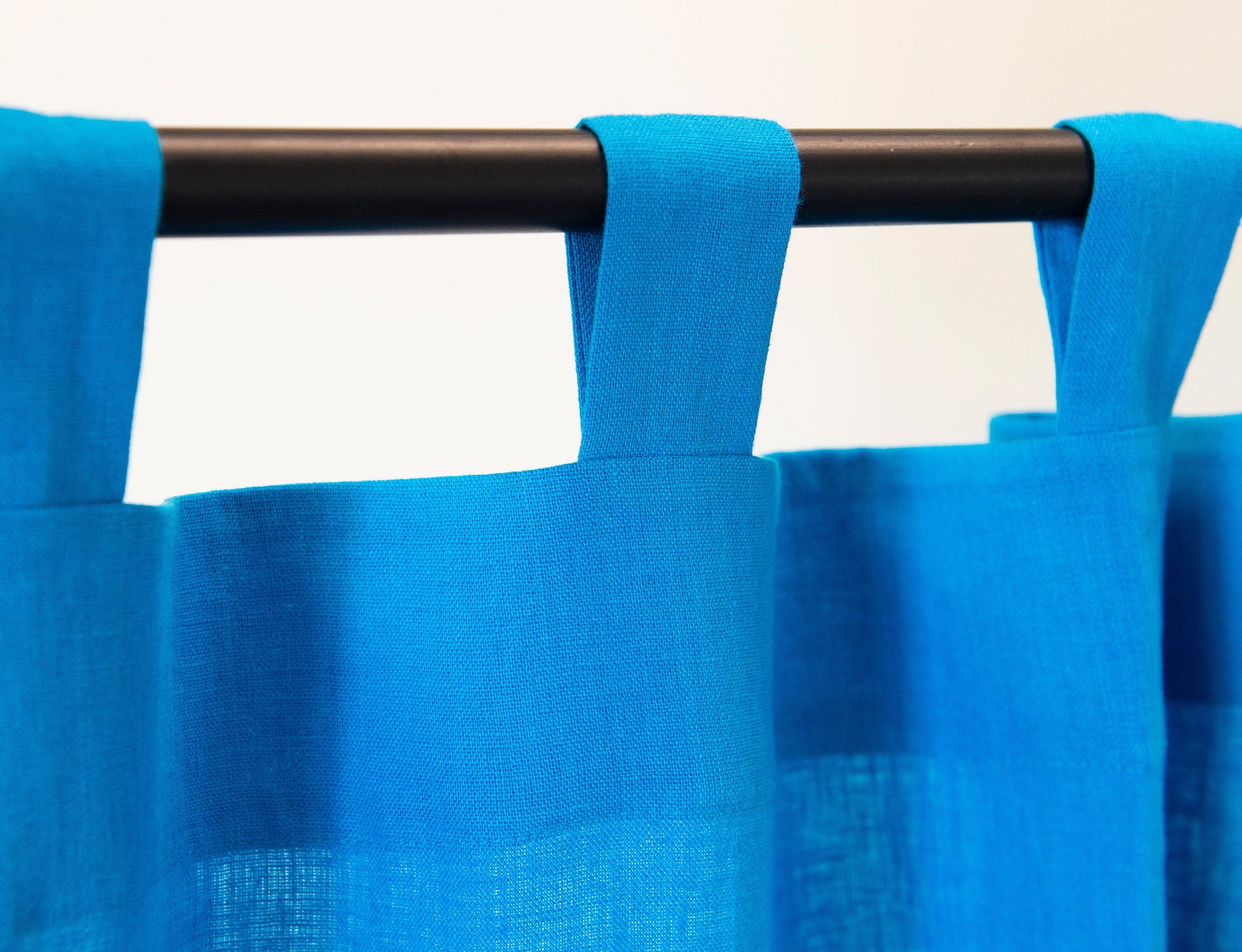 Sky Blue linen curtain with tab tops, showcasing a modern design and semi-sheer fabric.