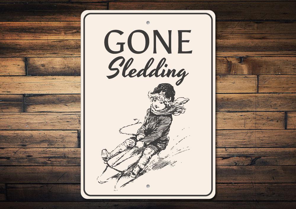 A festive Sledding Sign featuring cheerful winter imagery, perfect for Christmas decorations.