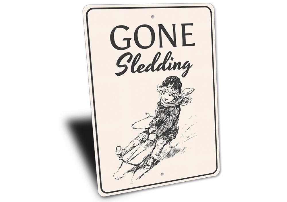 A festive Sledding Sign featuring cheerful winter imagery, perfect for Christmas decorations.