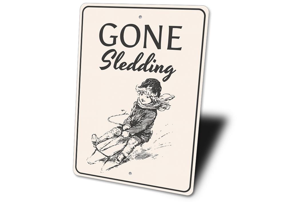 A festive Sledding Sign featuring cheerful winter imagery, perfect for Christmas decorations.