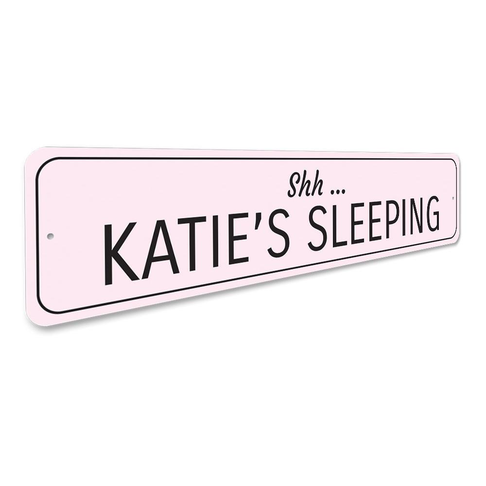 A decorative Sleeping Baby Sign made of high-quality aluminum, featuring customizable text for a child's room.