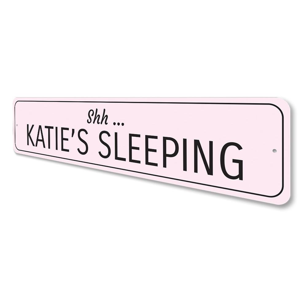 A decorative Sleeping Baby Sign made of high-quality aluminum, featuring customizable text for a child's room.