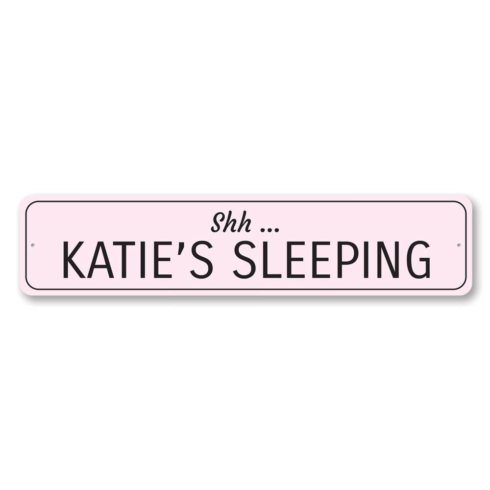 A decorative Sleeping Baby Sign made of high-quality aluminum, featuring customizable text for a child's room.