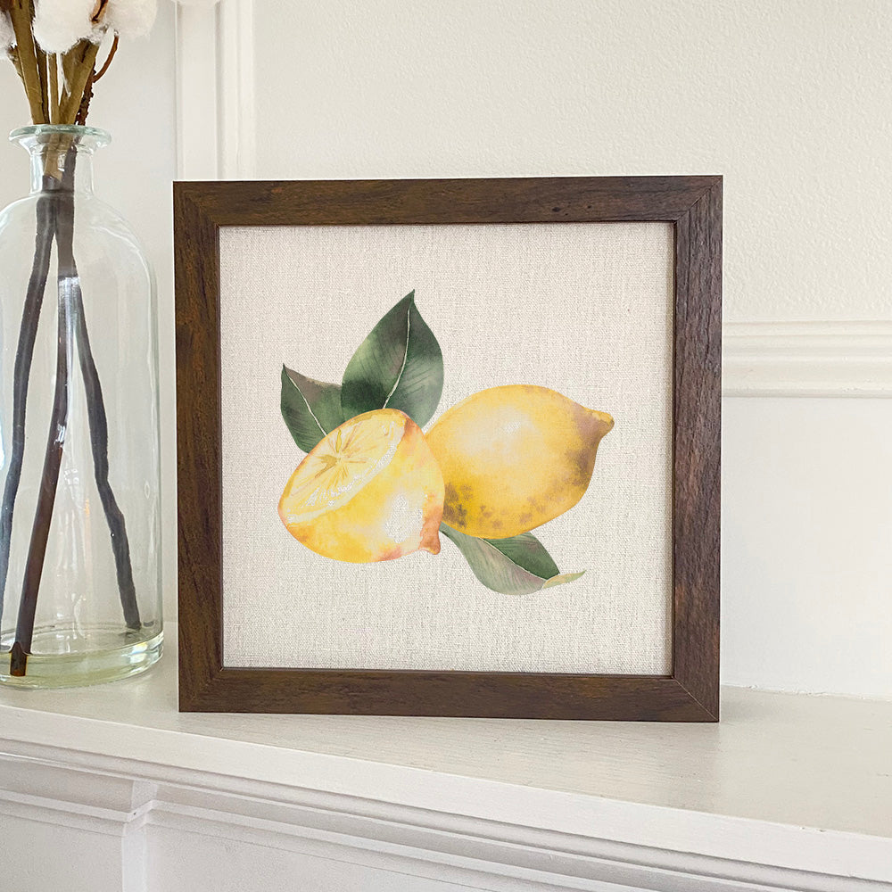 A beautifully framed Sliced Lemon sign with a linen-look background, available in walnut and white-washed frame options.