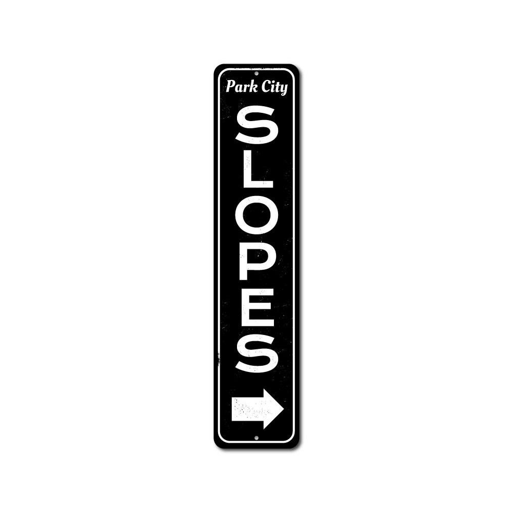 Slopes Arrow Vertical Sign made of high-quality aluminum, featuring a ski-themed design perfect for home decor.