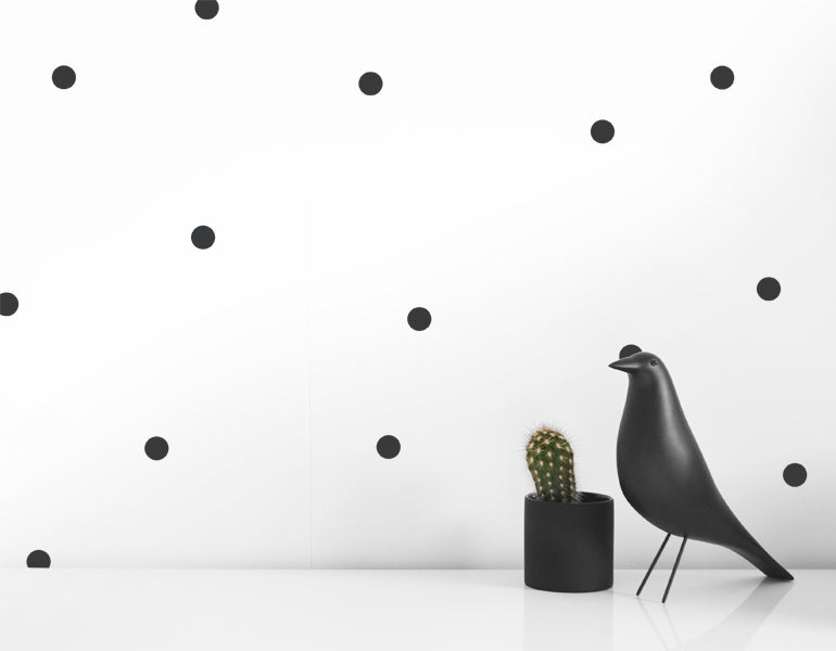 A collection of small dot wall decals in black and gray, perfect for modern nursery and home decor.