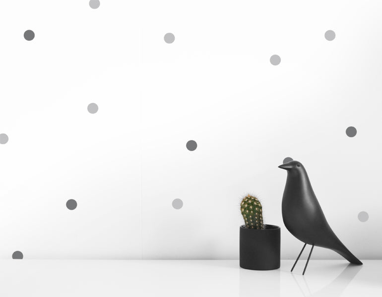 A collection of small dot wall decals in black and gray, perfect for modern nursery and home decor.