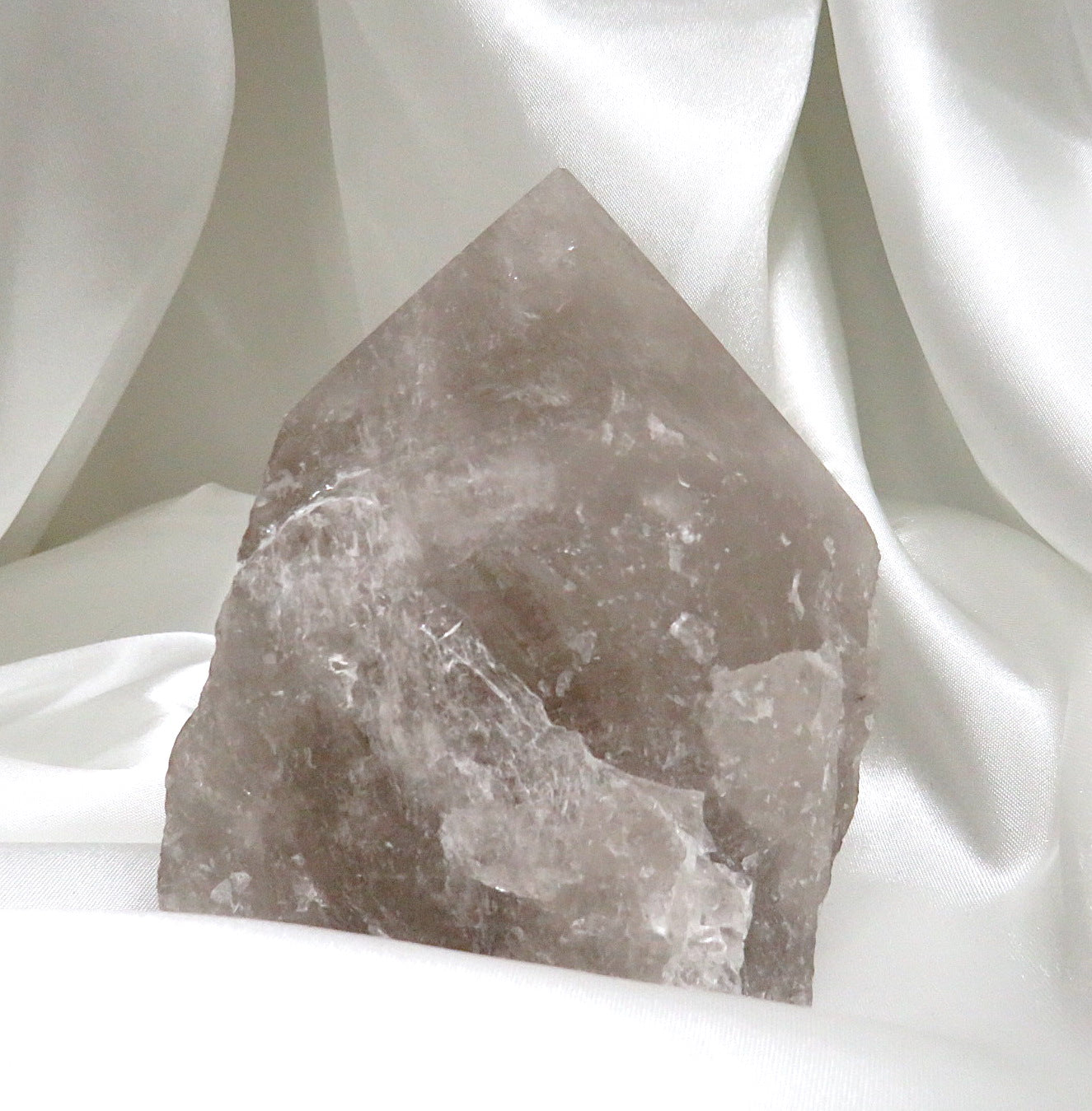 A beautiful Smoky Quartz Point crystal, showcasing its natural facets and grounding properties, perfect for healing and detoxification.