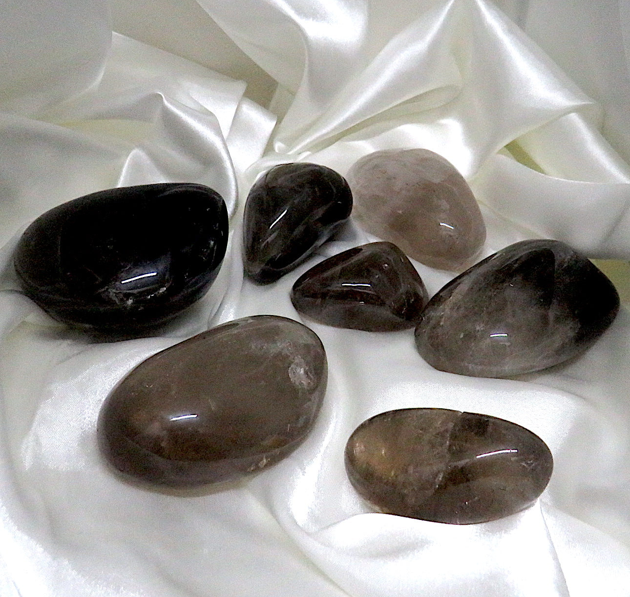 A polished freeform piece of Smoky Quartz showcasing its rich, dark hues and smooth surface, ideal for grounding and healing.