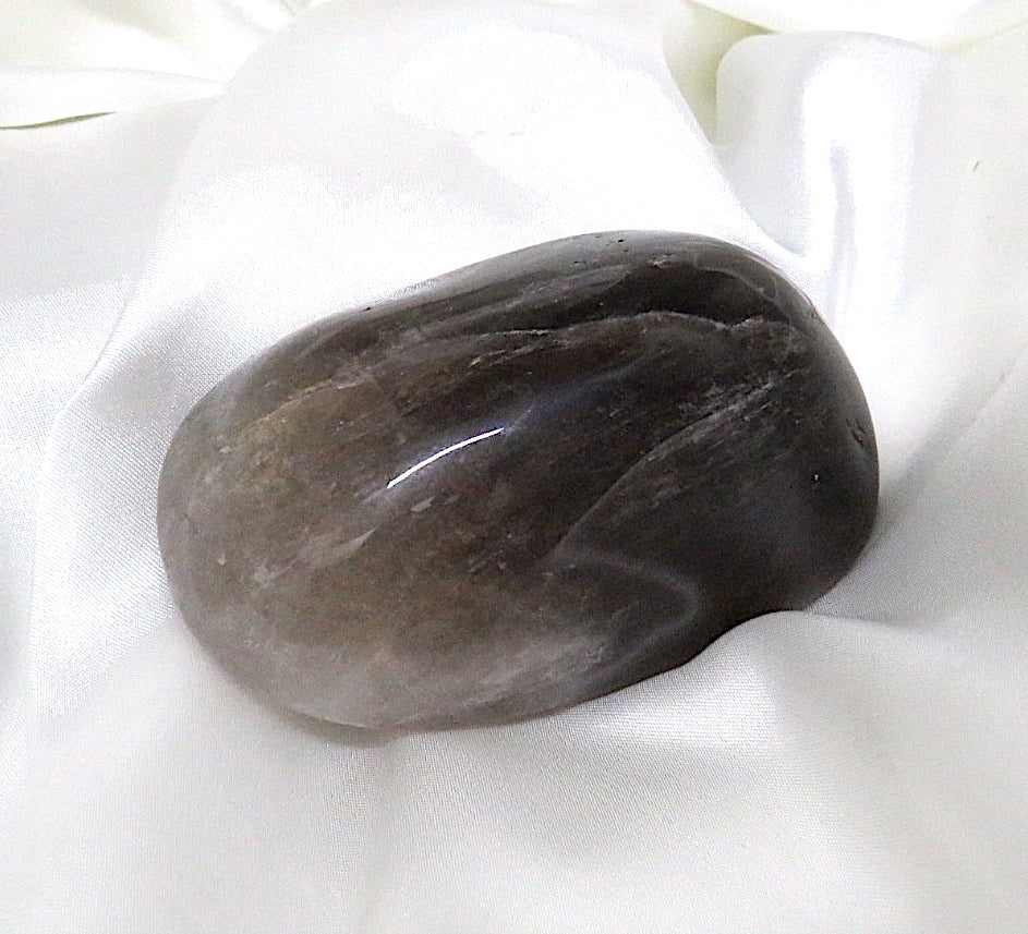 A polished freeform piece of Smoky Quartz showcasing its rich, dark hues and smooth surface, ideal for grounding and healing.