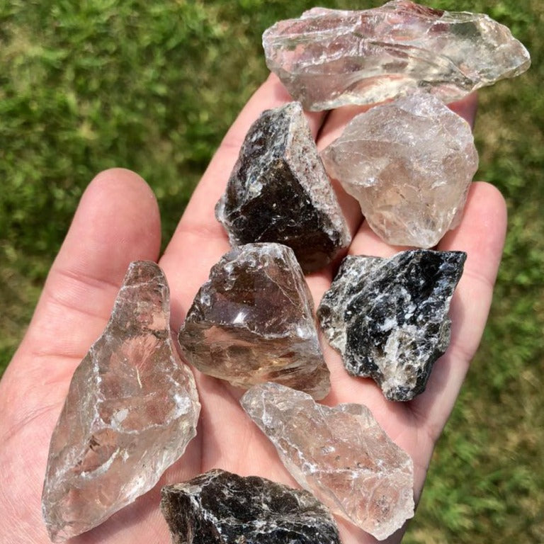 A collection of Smoky Quartz raw chunks showcasing their unique textures and colors, perfect for healing and grounding.