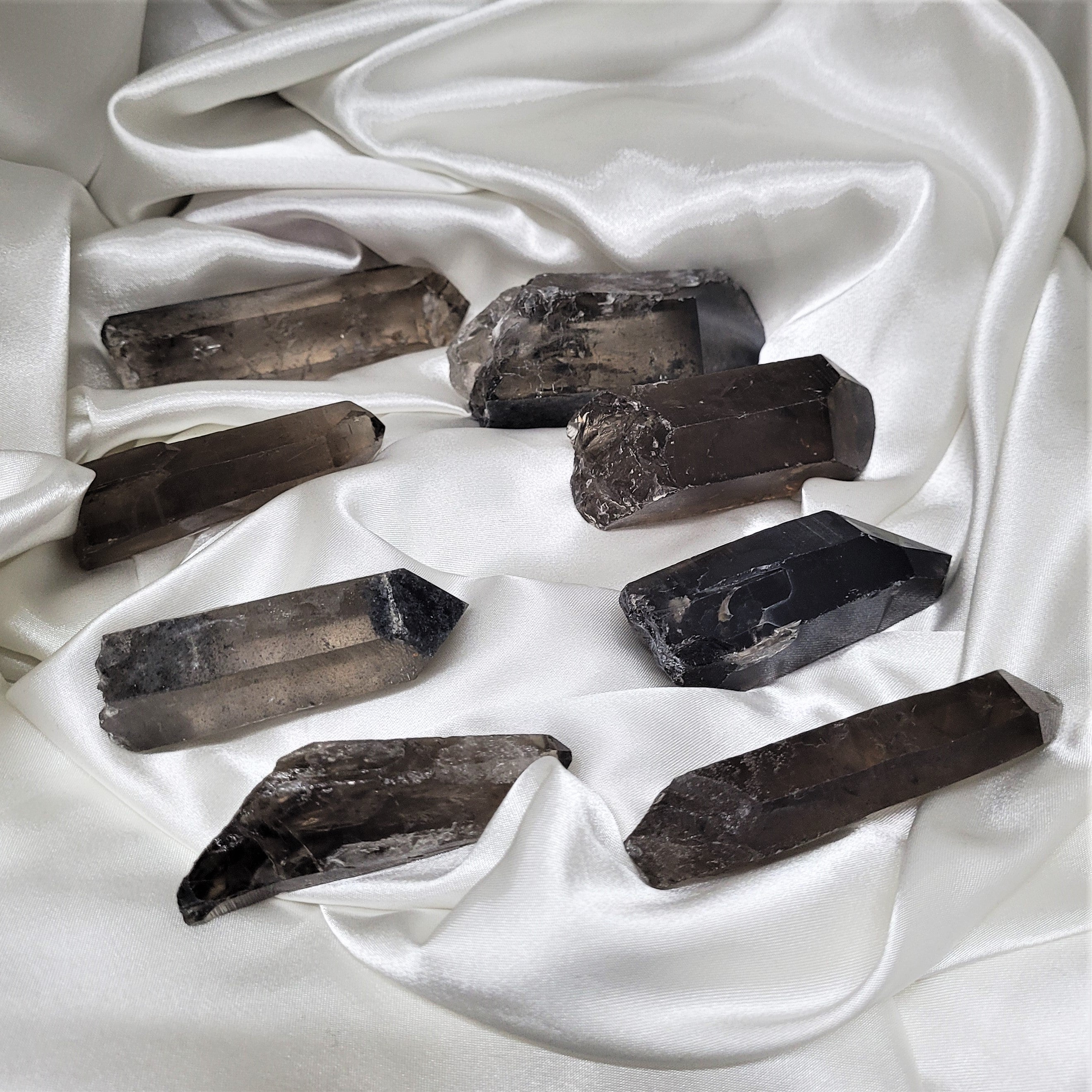 A collection of Smoky Quartz Raw Points showcasing their unique shapes and natural imperfections, perfect for meditation and energy work.