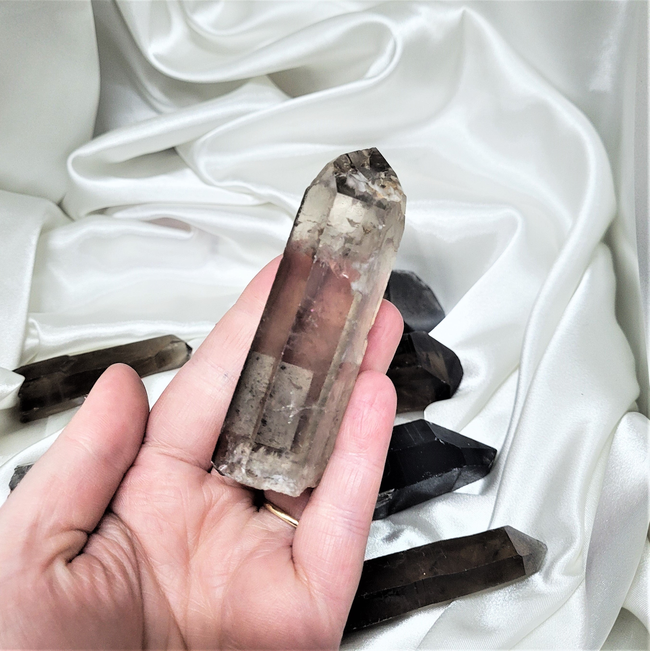 A collection of Smoky Quartz Raw Points showcasing their unique shapes and natural imperfections, perfect for meditation and energy work.