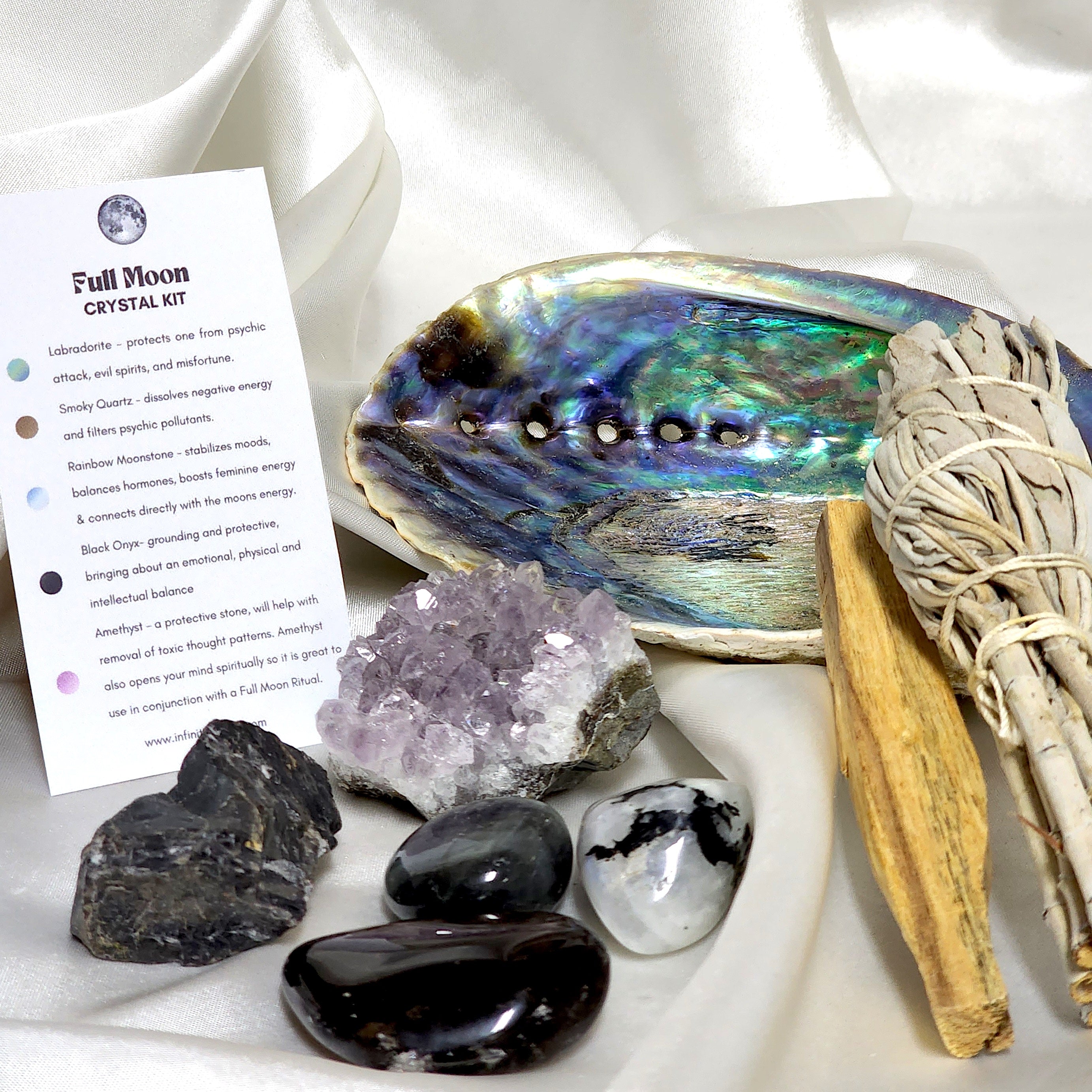 Smudge Kit featuring sage smudge stick, Palo Santo, abalone shell, and various healing crystals for Full Moon rituals.