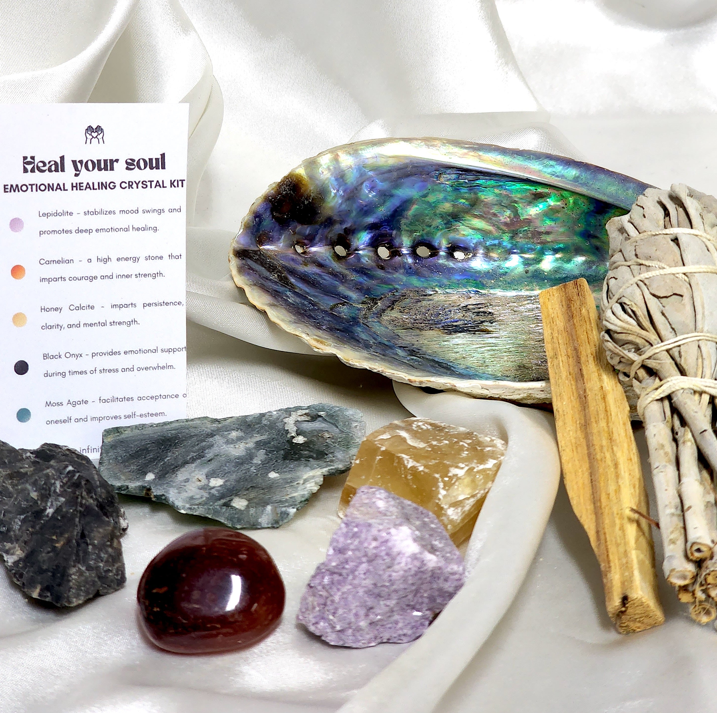 Smudge Kit: Heal Your Soul featuring sage smudge stick, Palo Santo, abalone shell, and various healing crystals for emotional healing.