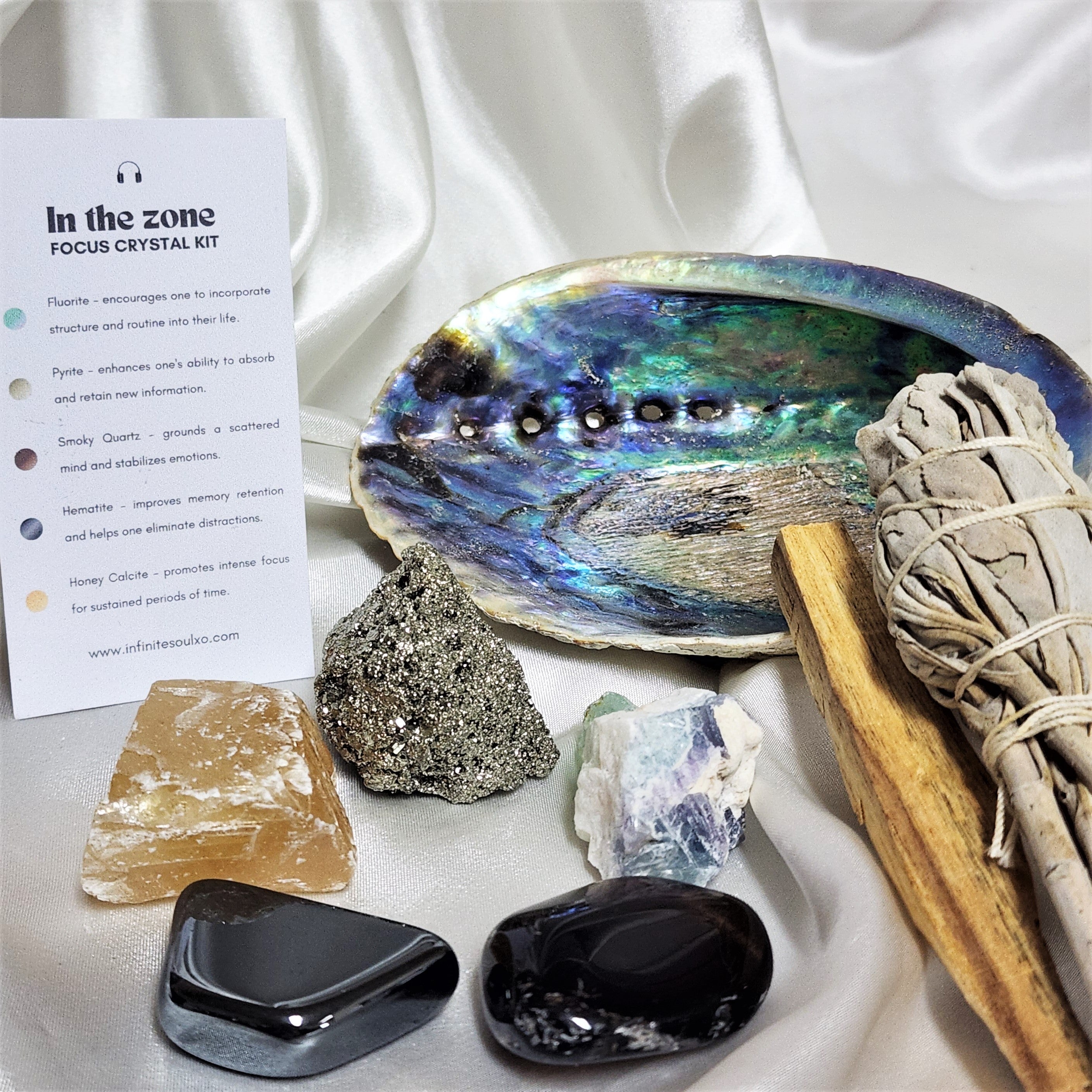 Focus Smudge Kit featuring sage smudge stick, Palo Santo, abalone shell, and various crystals for enhancing focus and meditation.