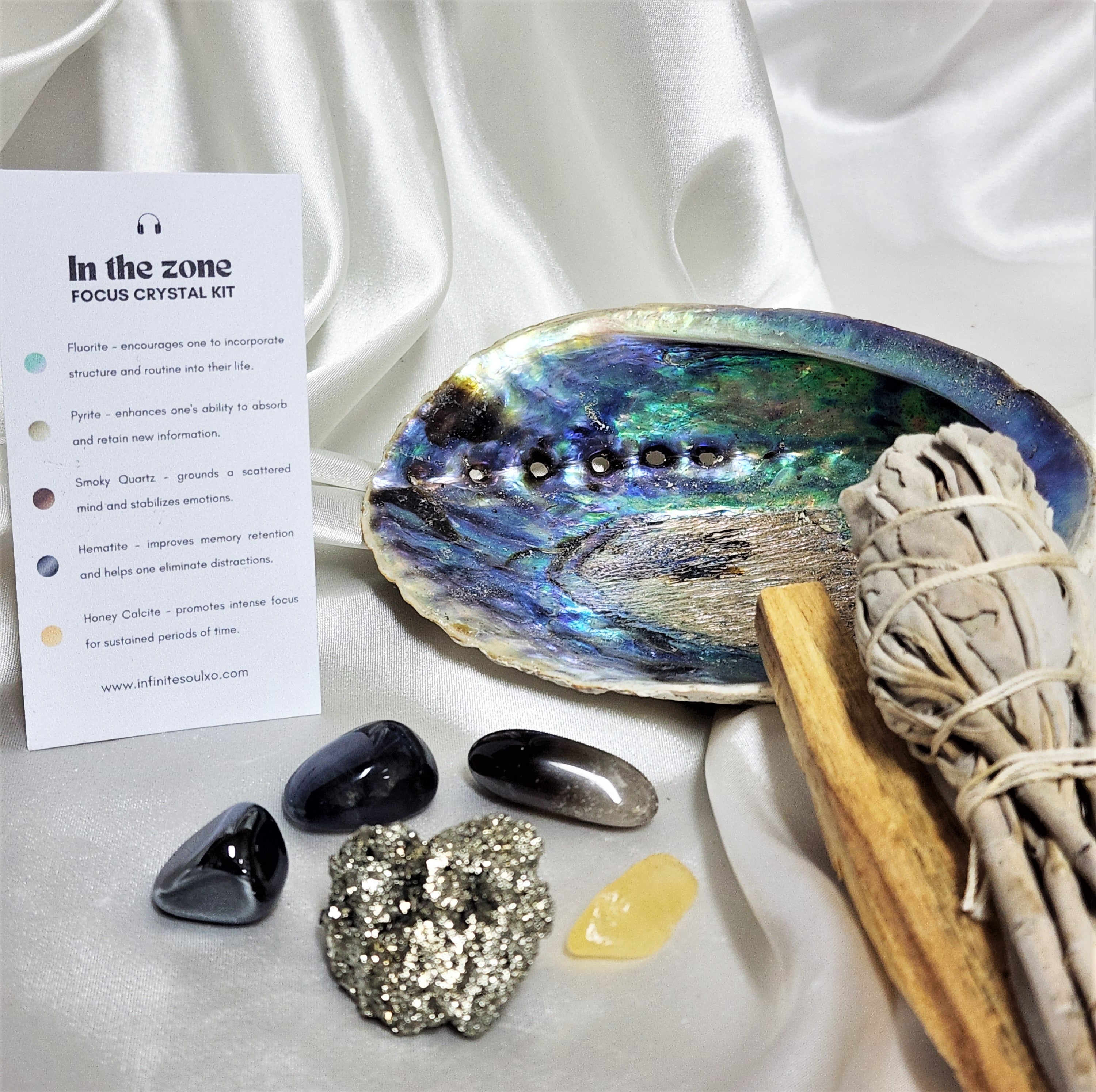 Focus Smudge Kit featuring sage smudge stick, Palo Santo, abalone shell, and various crystals for enhancing focus and meditation.