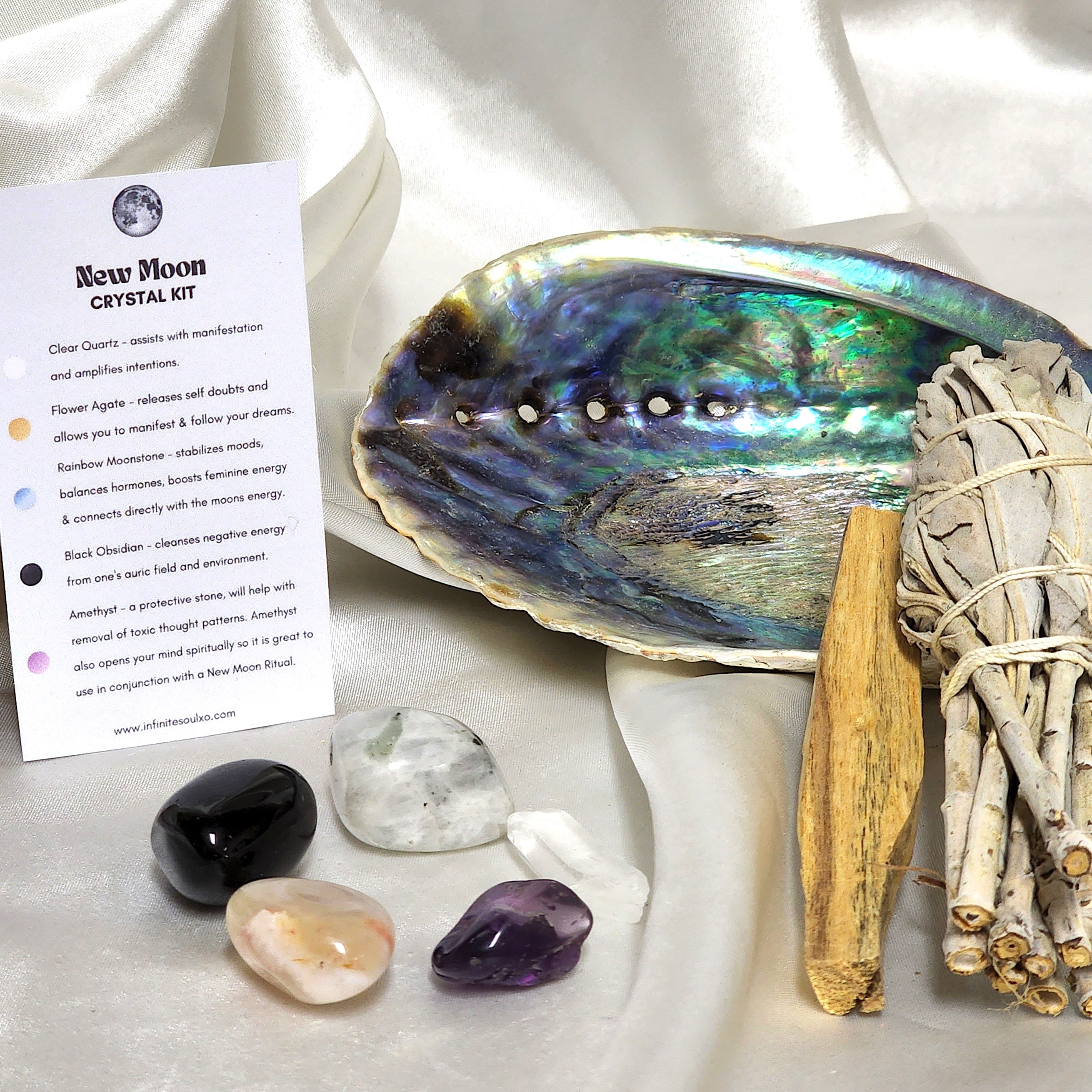 Smudge Kit: New Moon Kit featuring sage smudge stick, Palo Santo, abalone shell, and various healing crystals.