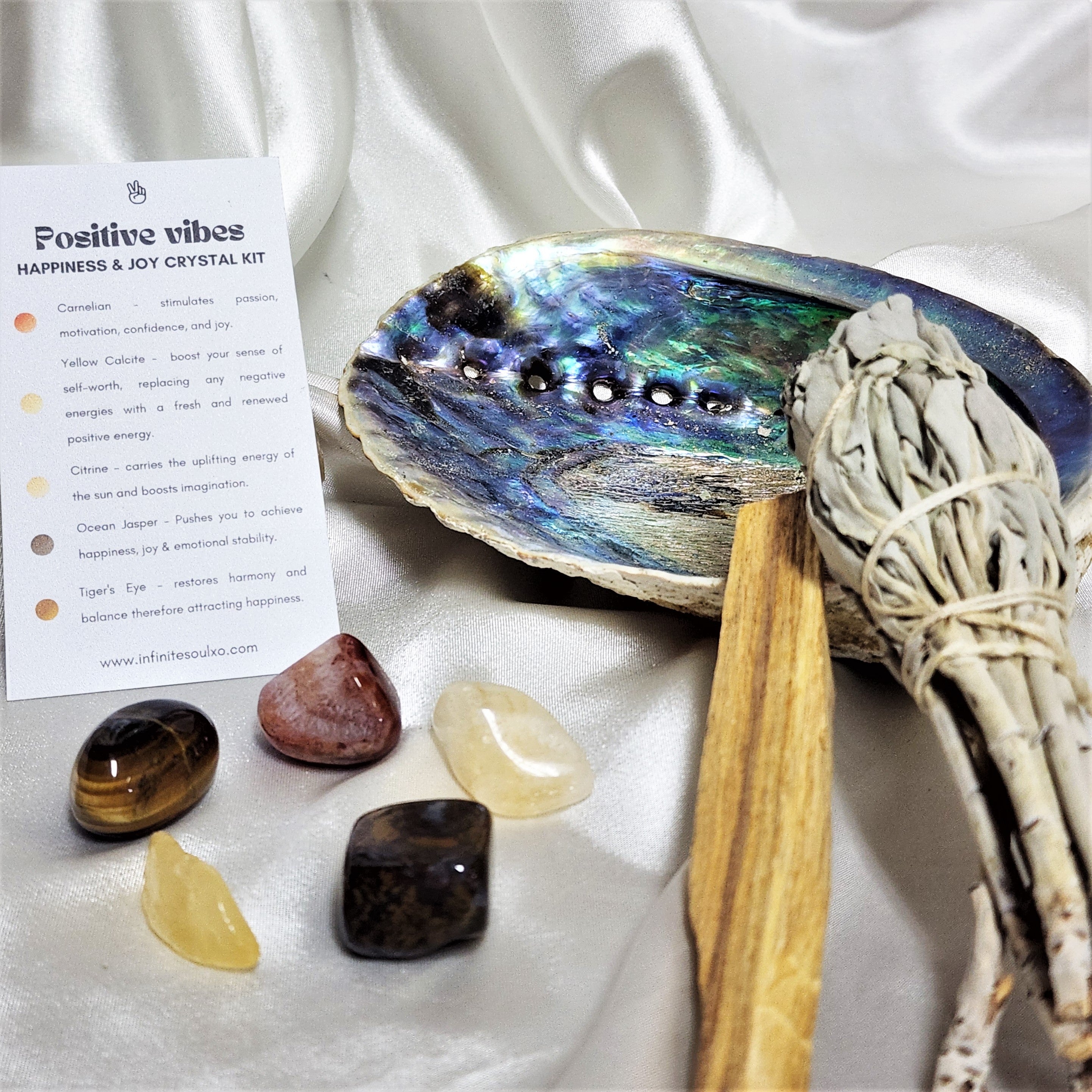 Happiness & Joy Smudge Kit featuring sage, palo santo, abalone shell, and five unique crystals for positive energy.