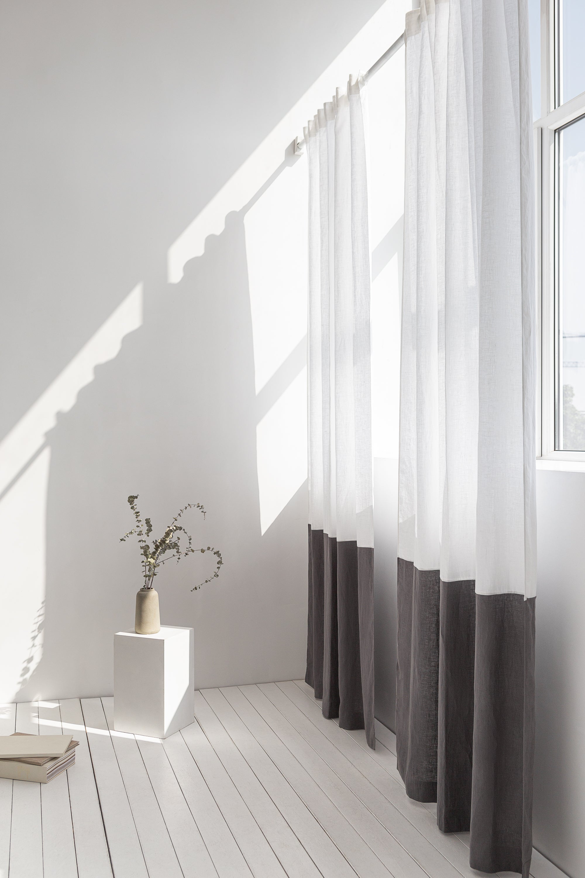 Elegant Snow White and Grey linen curtains with multifunctional tape heading, showcasing a modern two-tone design in a bright room.