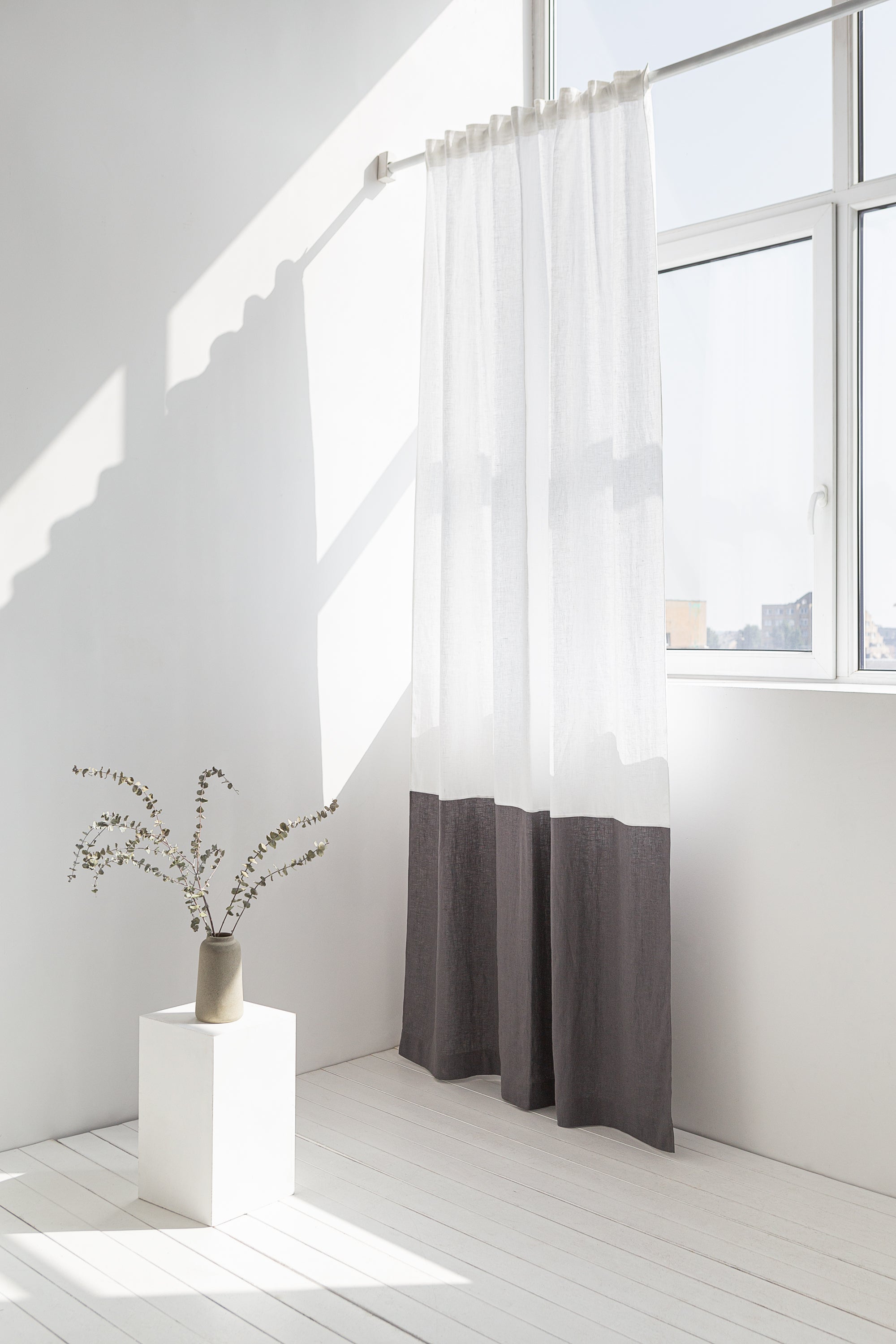 Elegant Snow White and Grey linen curtains with multifunctional tape heading, showcasing a modern two-tone design in a bright room.