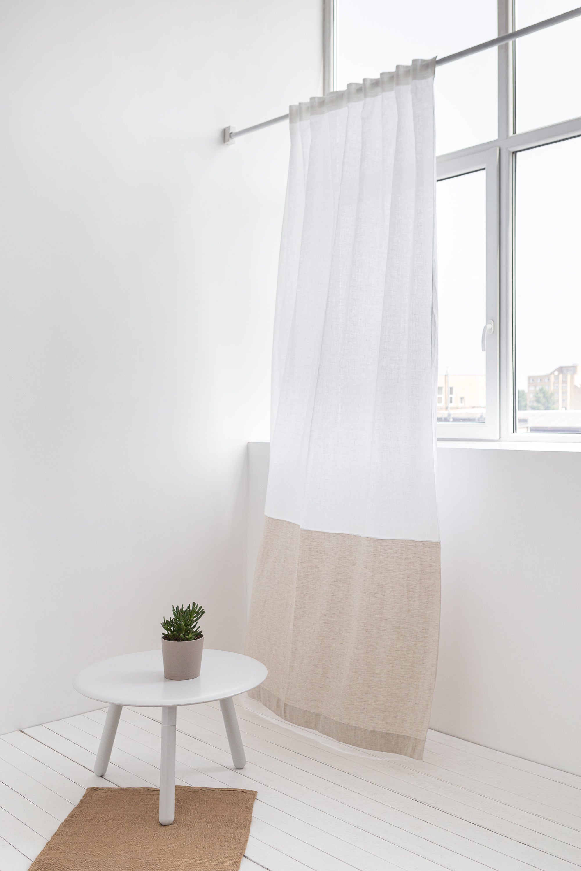 Elegant Snow White and Grey linen curtains with multifunctional tape heading, showcasing a modern two-tone design in a bright room.