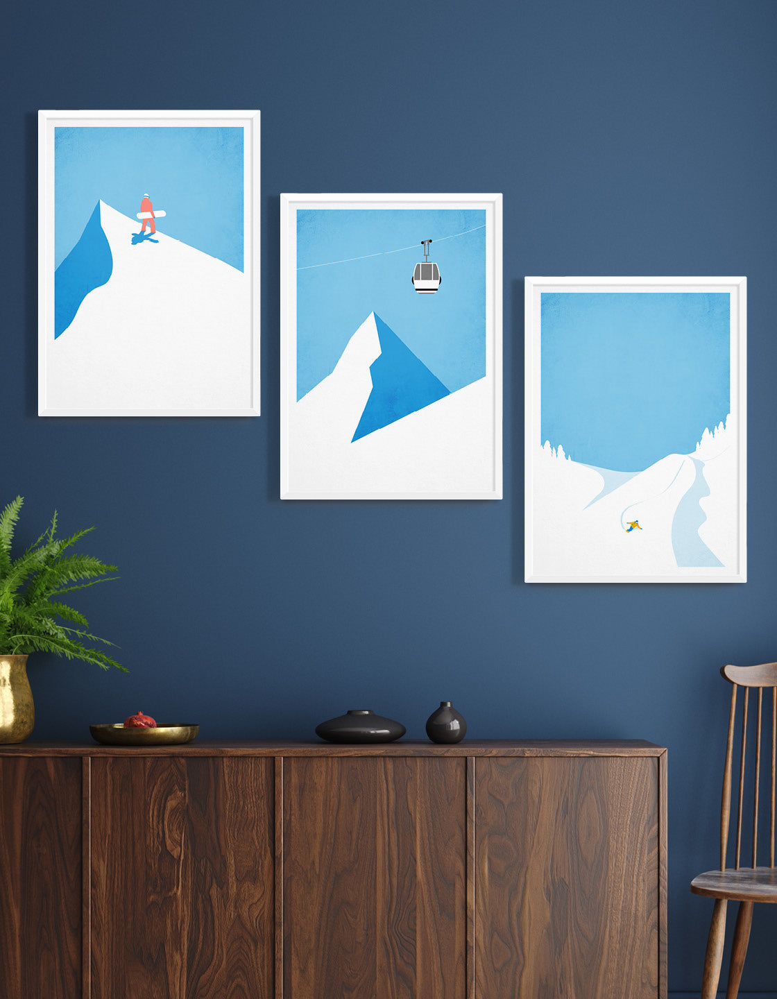 A collection of three minimalistic snowboard posters arranged for a gallery wall display, showcasing winter sports themes.