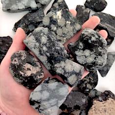 A collection of Snowflake Obsidian Rough Slabs showcasing unique black and white patterns, ideal for healing and meditation.