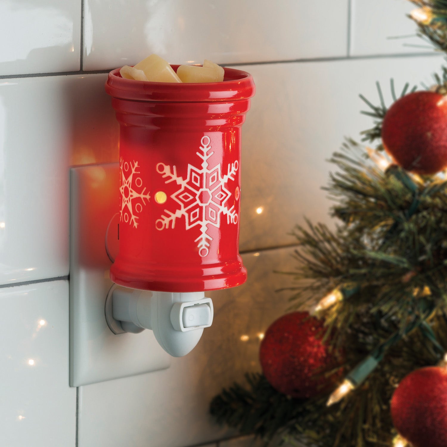 Snowflake Pluggable Warmer with bold red glaze and white snowflake design, perfect for seasonal decor and fragrance.