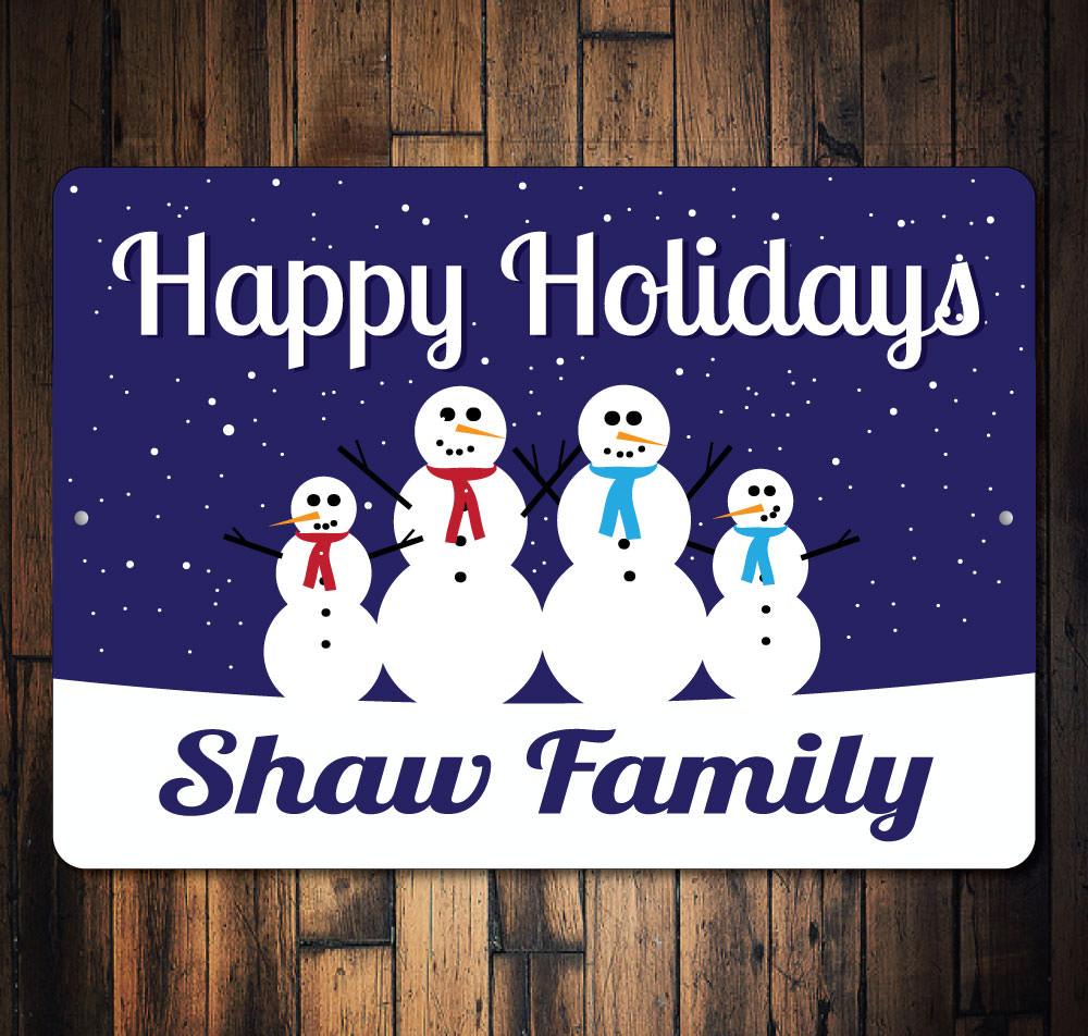 A festive Snowmen Sign featuring cheerful snowmen in a winter scene, perfect for Christmas decorations.