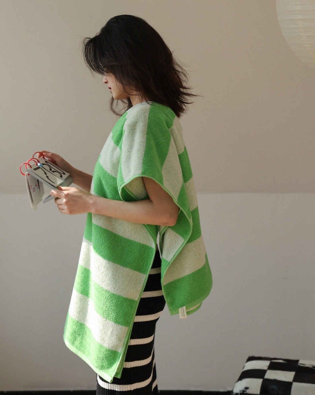 Soft and absorbent stripe bath towel made from 100% organic combed cotton, featuring a trendy green stripe design.