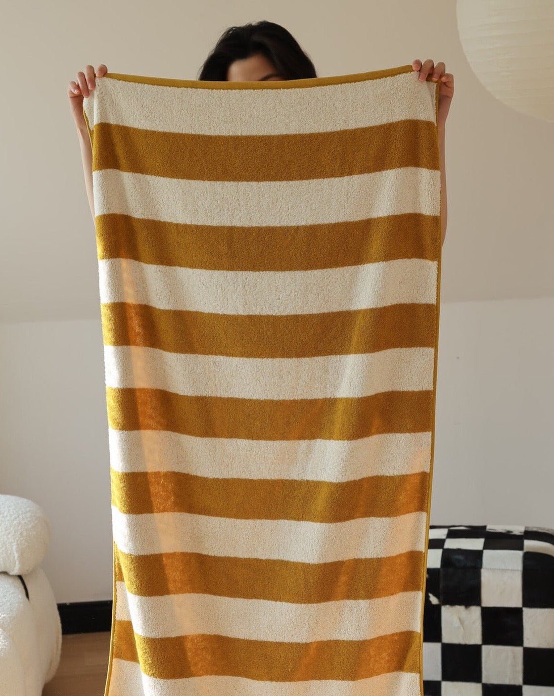 Soft and absorbent stripe bath towel made from 100% organic combed cotton, featuring a trendy green stripe design.