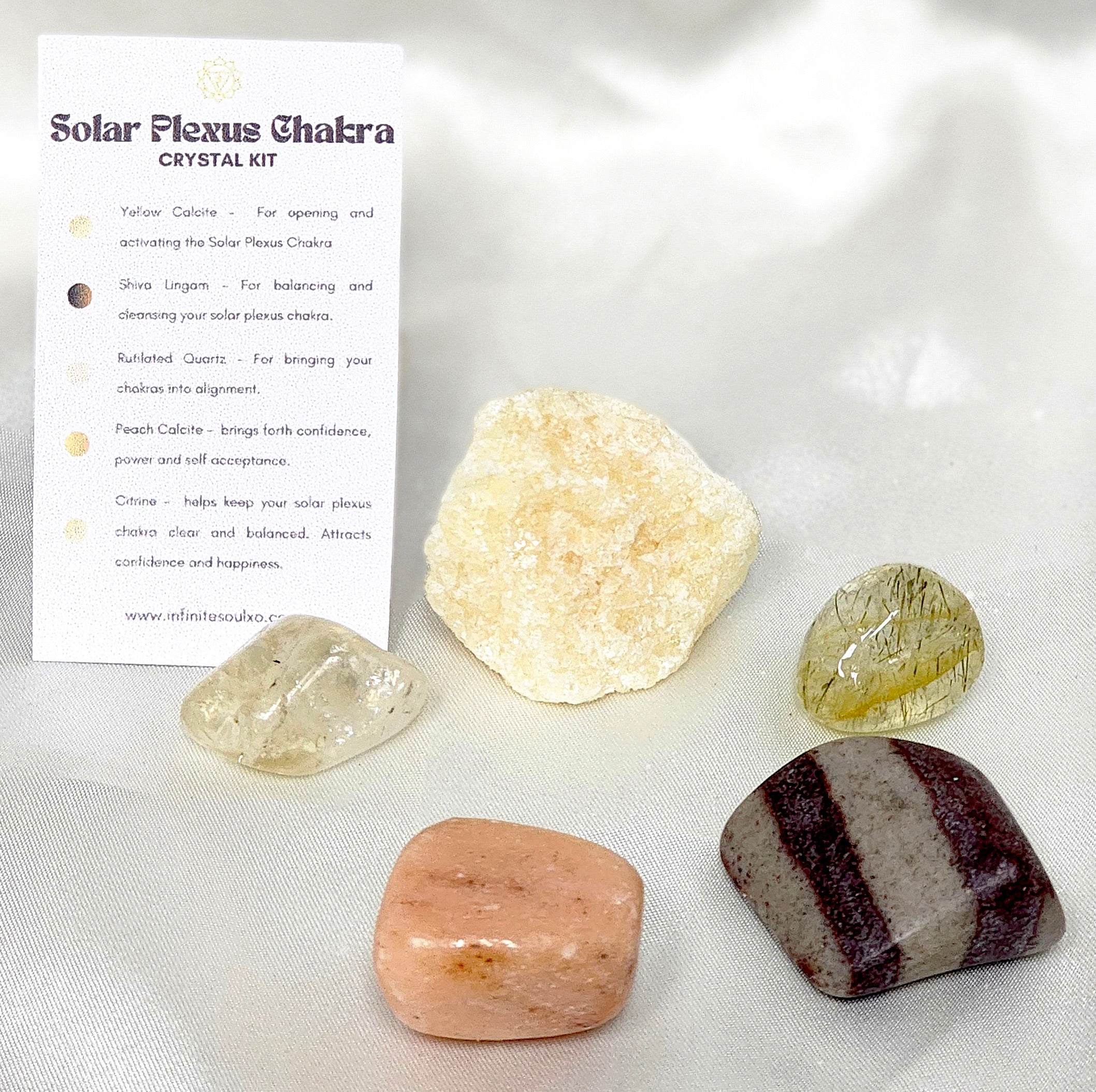 A collection of crystals including Yellow Calcite, Shiva Lingam, Rutilated Quartz, Peach Calcite, and Citrine, arranged beautifully for the Solar Plexus Chakra Crystal Kit.