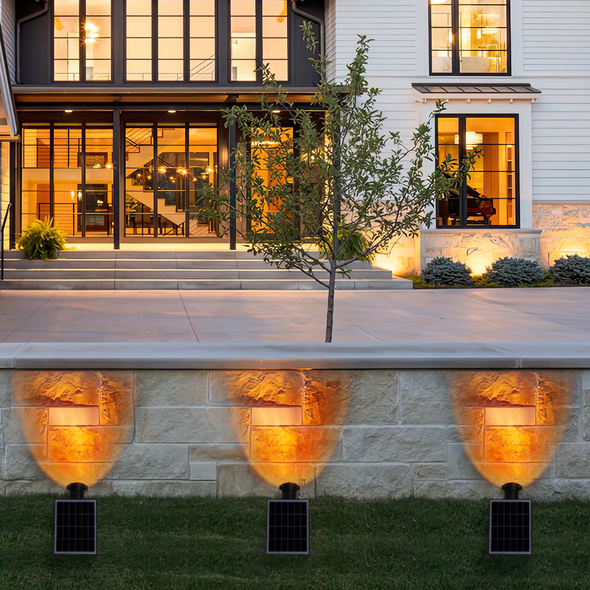 Solar Power Outdoor Sunset Projector Light illuminating a garden pathway with a warm sunset projection.