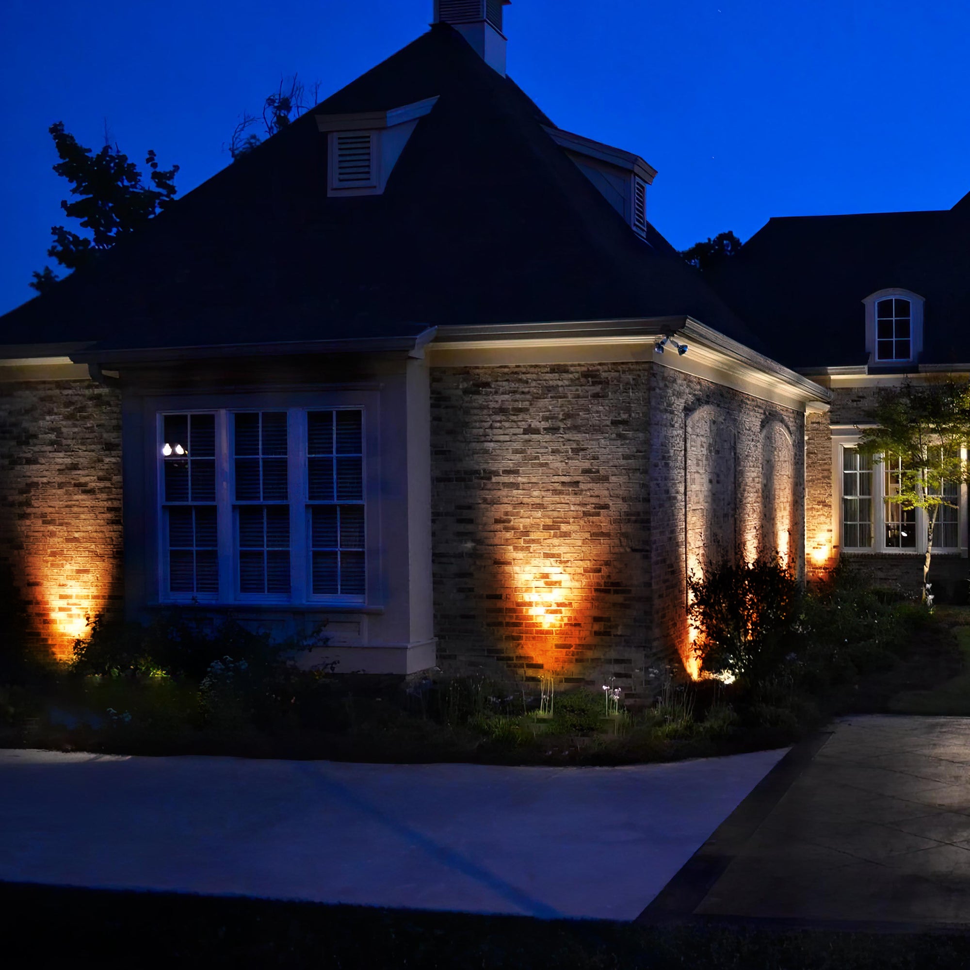 Solar Power Outdoor Sunset Projector Light illuminating a garden pathway with a warm sunset projection.