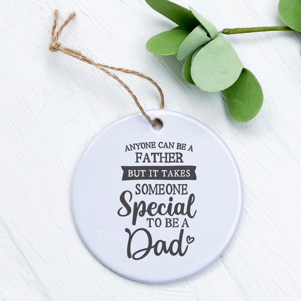 A beautifully crafted porcelain ornament featuring a heartfelt design for dads, measuring 2.75 inches in diameter with a glossy finish.