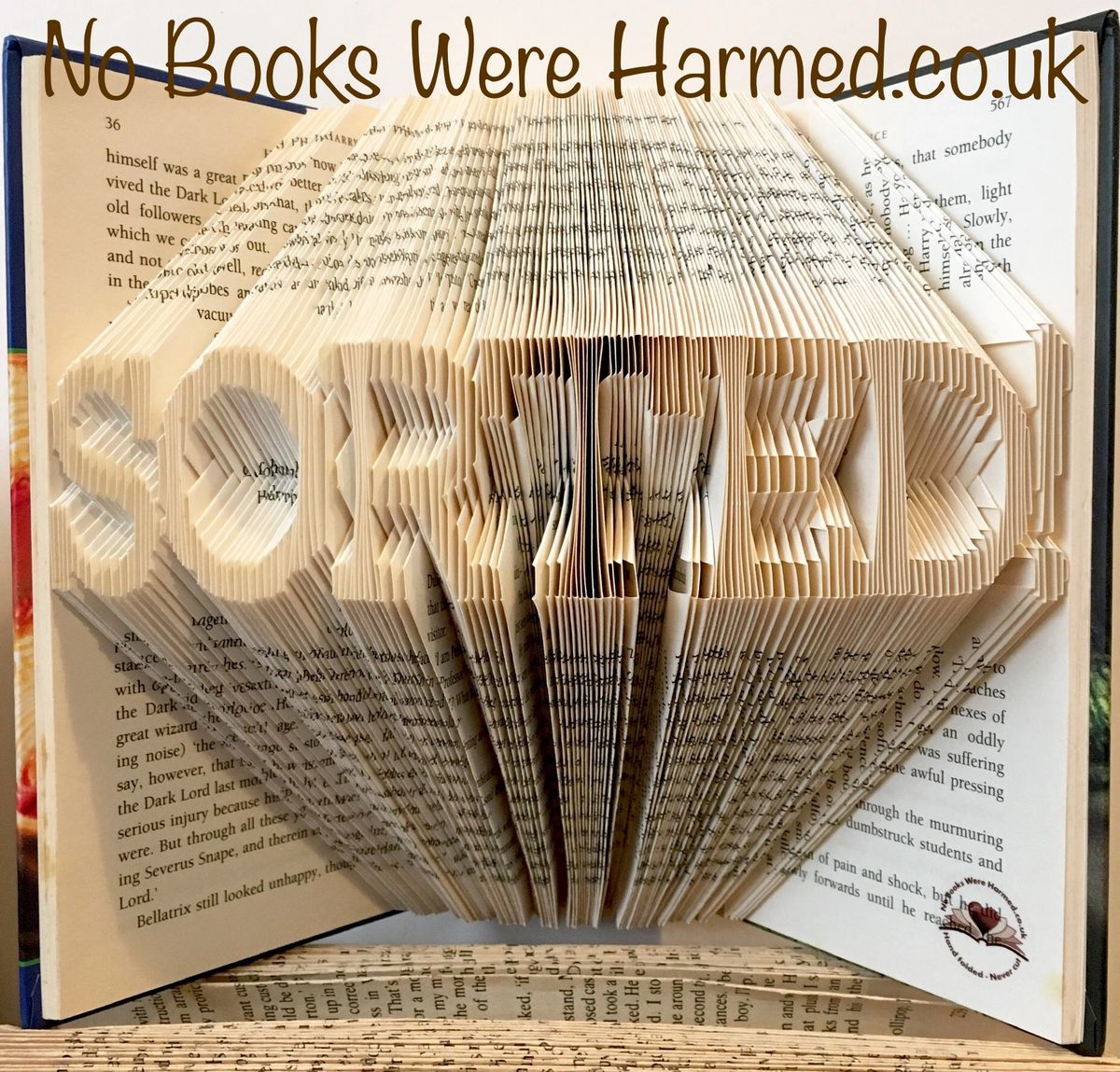 A beautifully crafted hand-folded book art piece made from vintage books, showcasing intricate folds and unique designs.