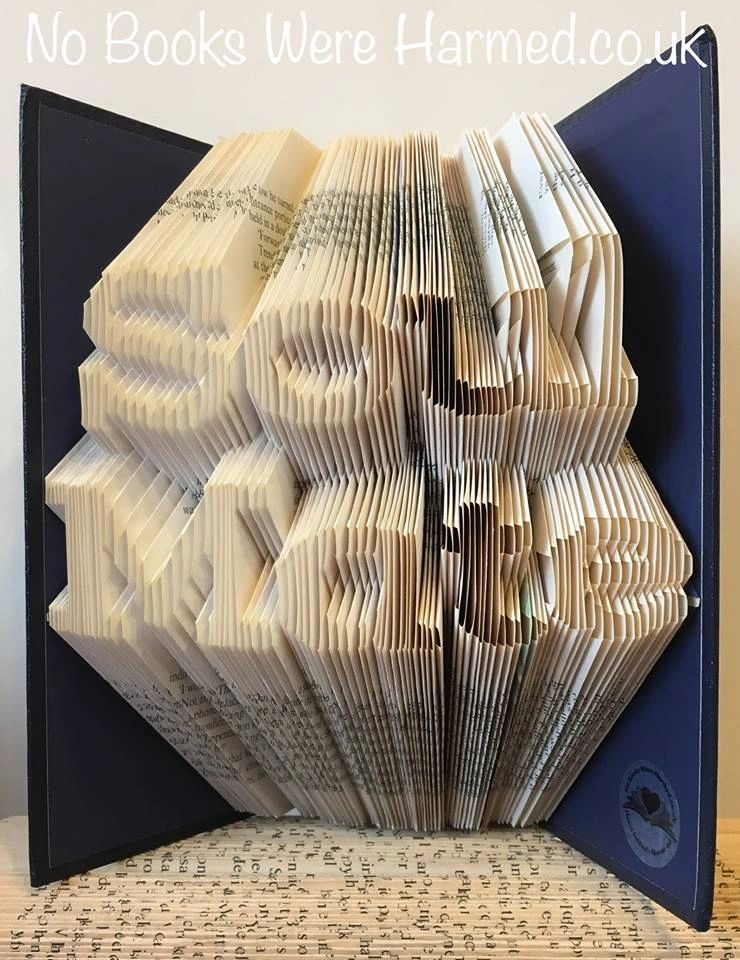 Handcrafted 'Soul Mate' book art made from vintage books, showcasing intricate folds and unique designs.