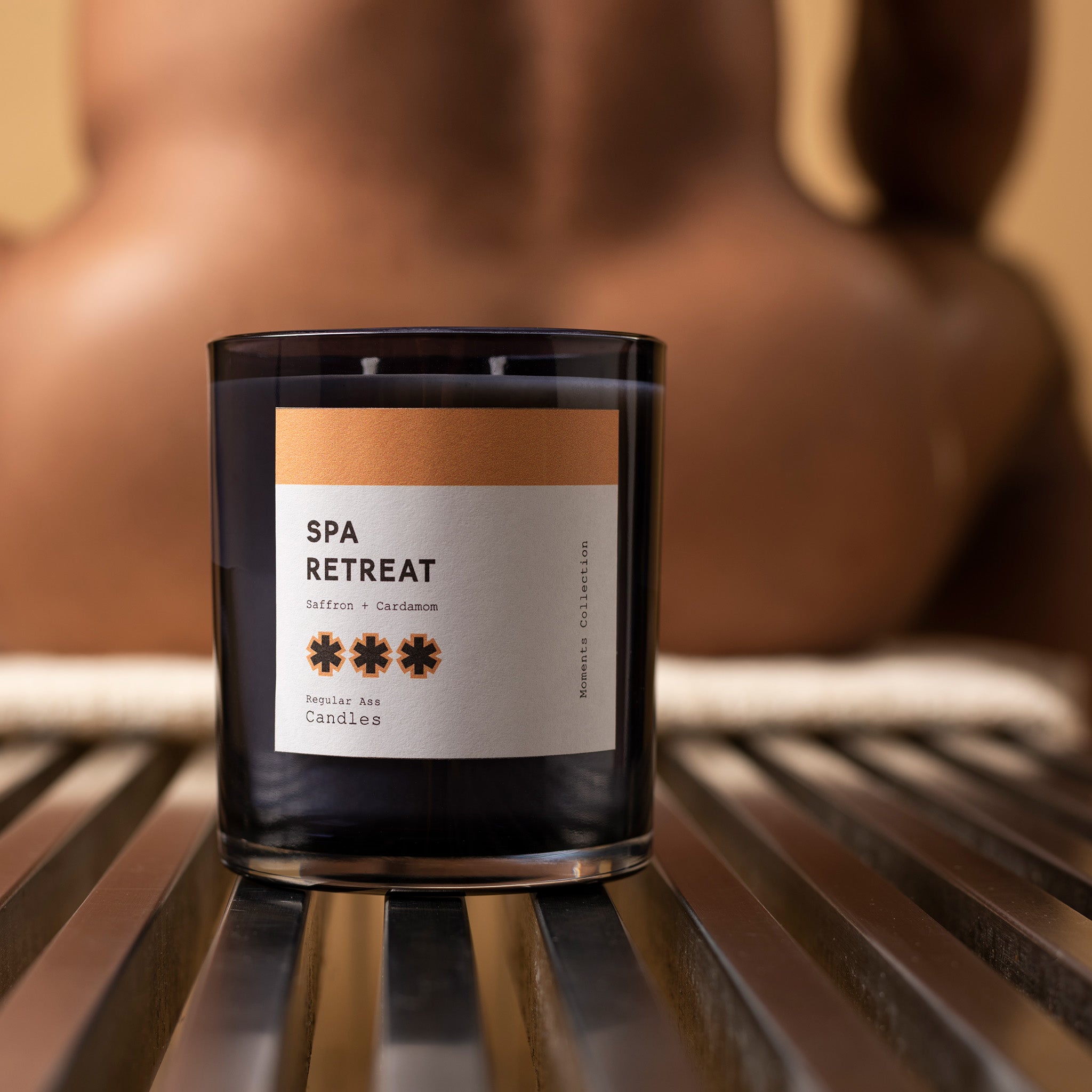 A beautifully crafted 11oz candle in a reusable jar, featuring a warm saffron and cardamom scent, perfect for creating a spa-like atmosphere at home.