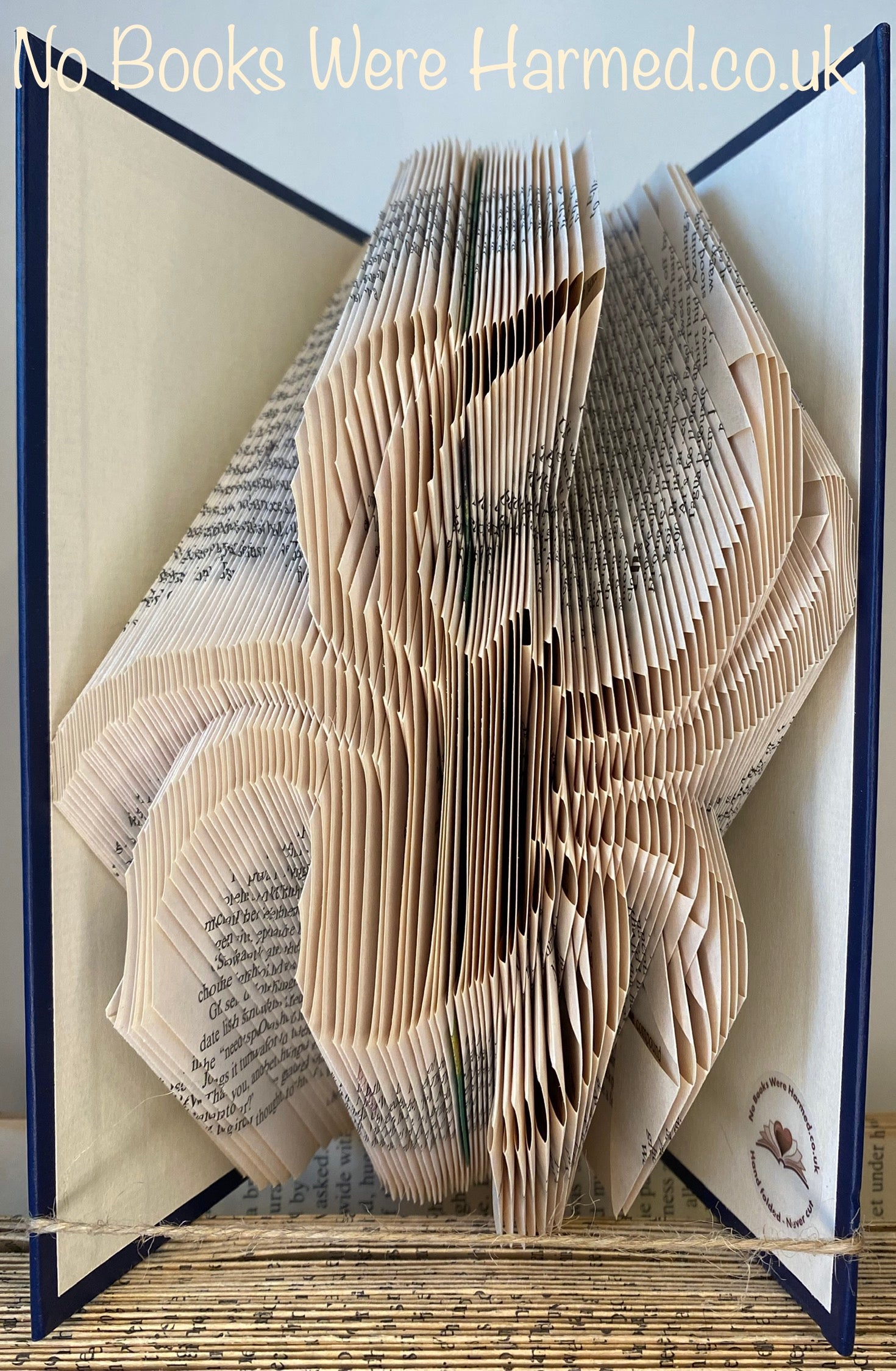 Hand folded spider book art made from vintage books, showcasing intricate folds and unique design.