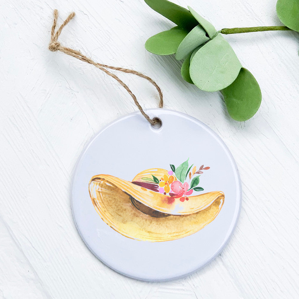 A beautifully crafted porcelain ornament featuring a spring floral hat design, showcasing vibrant colors and a glossy finish.