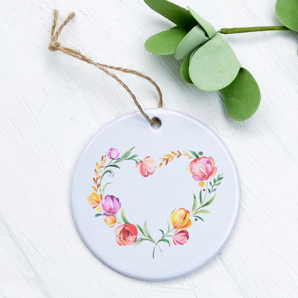 A beautifully crafted porcelain Spring Heart Wreath ornament featuring vibrant colors and intricate designs, perfect for seasonal decor.